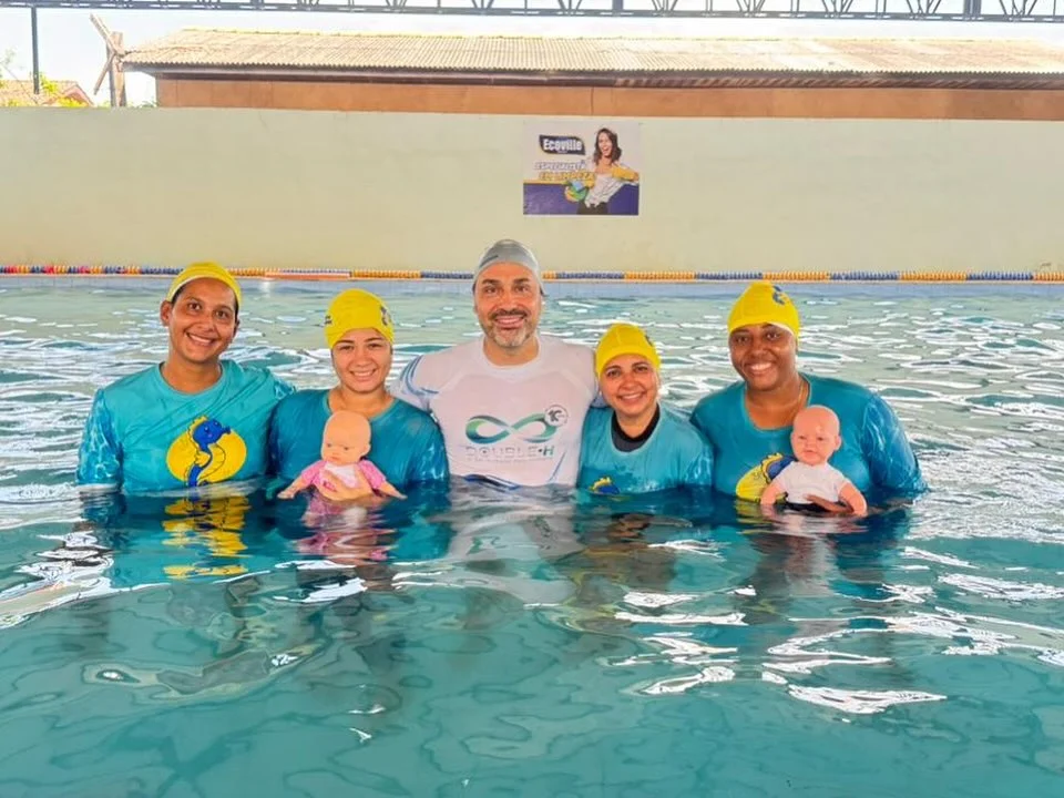 Professores e alunos da Acqua Stilo na piscina, incluindo um bebê